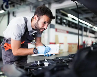 Mechanic working on a car in a garage